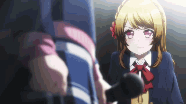 a girl in a school uniform is holding a microphone in front of her