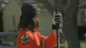 a sign that says tariffs on with a person holding a hockey stick