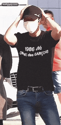 a man wearing a mask and a 1986 t-shirt