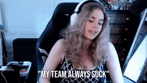a woman wearing headphones is sitting in front of a laptop computer and saying `` my team always suck '' .