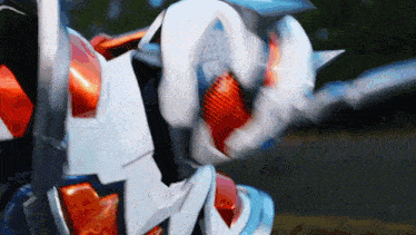 a close up of a robot 's head with a red and blue stripe on it