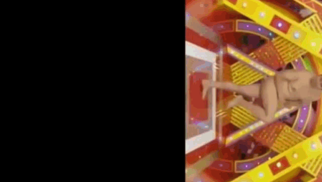 a naked man is flying through the air in a colorful room .