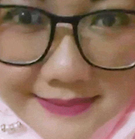 a close up of a woman wearing glasses and pink lipstick .