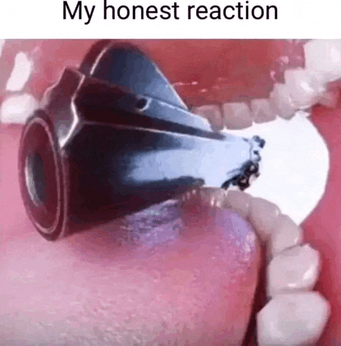 a close up of a person 's mouth with a gun coming out of it .