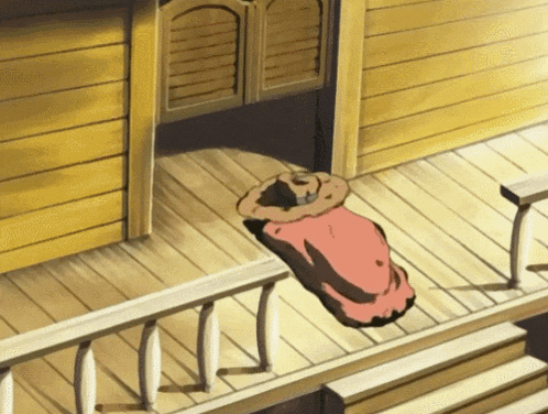 a cowboy hat is laying on a wooden porch