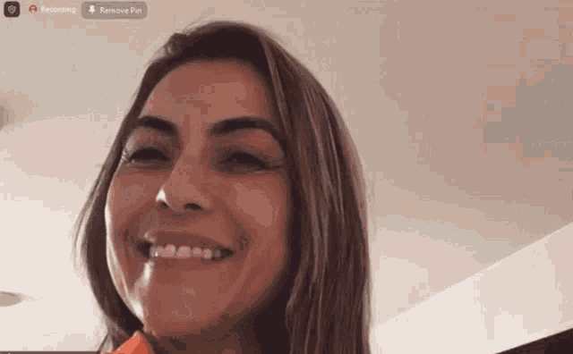 a woman is smiling in front of a screen that says remove pin
