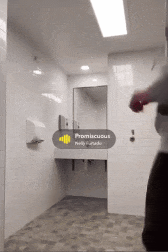 a bathroom with promiscuous by nelly furtado