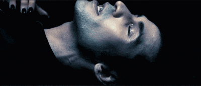 a man with rings on his fingers is laying down