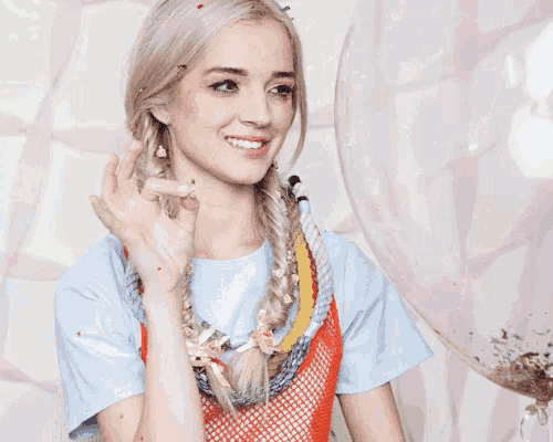 a woman is covered in confetti while making a funny face