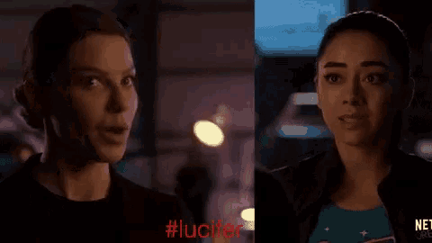 two women are standing next to each other in a dark room and the word lucifer is on the bottom of the screen .