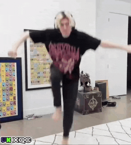 a person in a black shirt is jumping in the air while wearing headphones ..