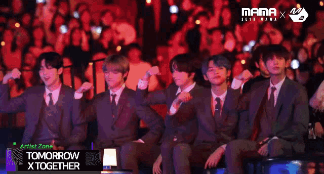 a group of young men in suits and ties are sitting in front of a crowd and the words tomorrow x together are on the bottom