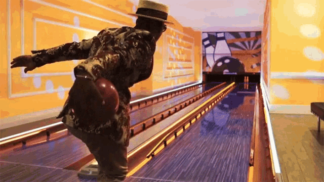 a man in a hat is throwing a bowling ball down a bowling alley