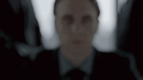 a blurry picture of a man 's face in a suit
