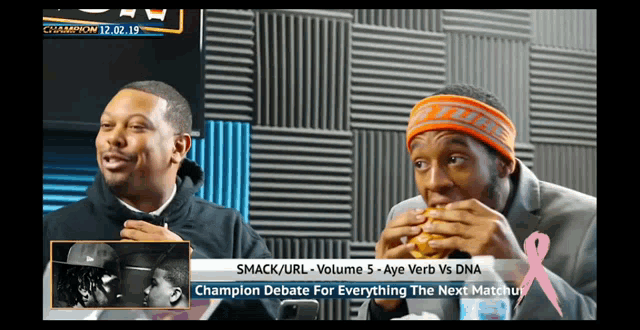 a man is eating a hamburger in front of a screen that says champion debate for everything the next match