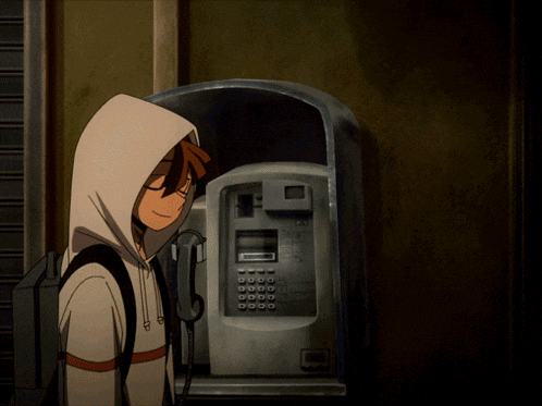a boy standing next to a payphone that says i 'm a on it