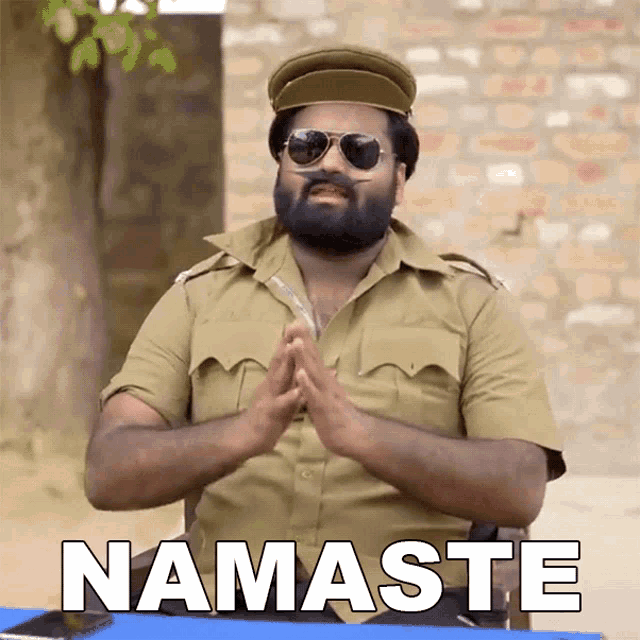 a man with a beard wearing a hat and sunglasses says namaste