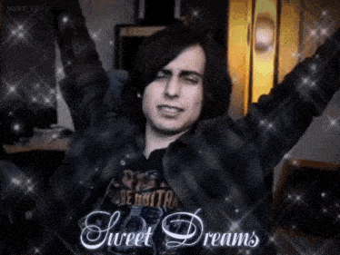 a man with his arms outstretched is wearing a shirt that says ' sweet dreams ' on it