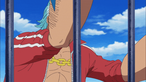 a man in a red shirt is behind bars