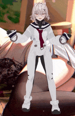a girl in a white suit is standing in front of a couch