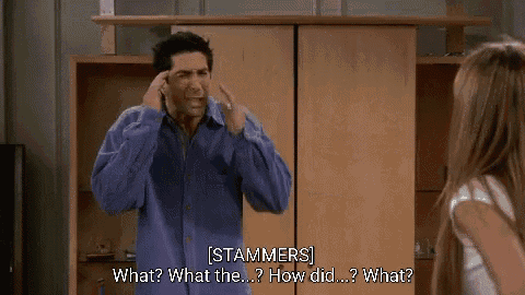 a man in a blue shirt is talking to a woman in a living room and says what what the how did what
