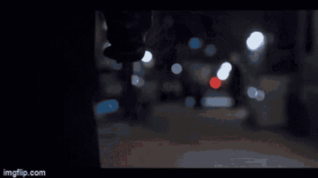 a blurry picture of a person walking down a street at night with the words imgflip.com at the bottom
