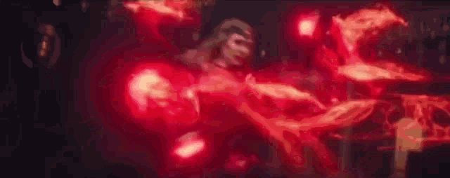 a close up of a person with red lights coming out of their hands and arms .