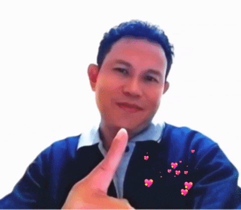 a man in a blue jacket giving a thumbs up sign