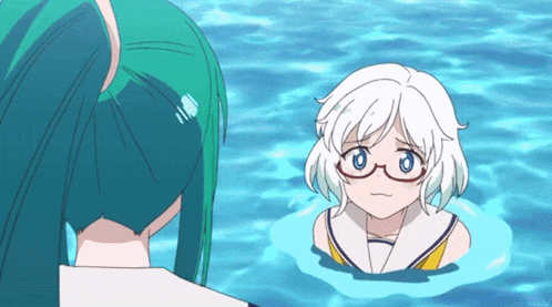 a girl with white hair and glasses is standing in the water
