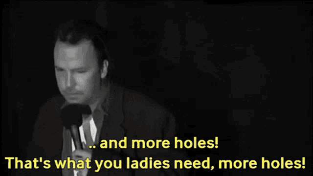 a man speaking into a microphone with the words and more holes