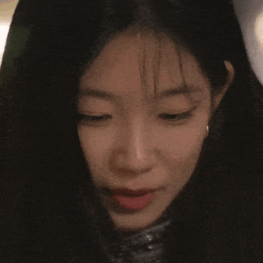 a close up of a woman 's face with a serious look on her face