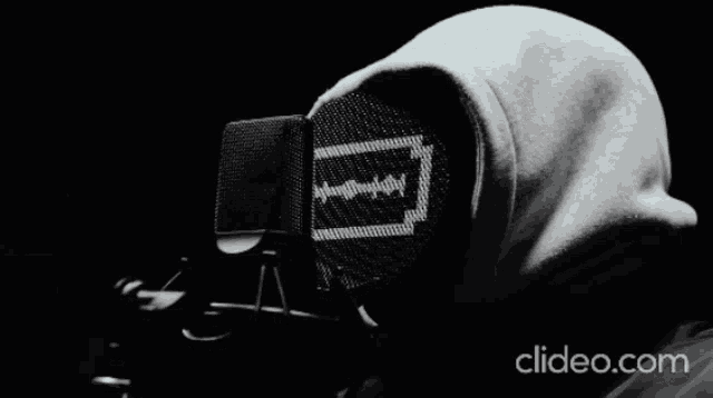 a black and white photo of a person wearing headphones and a hoodie with clideo.com in the bottom right corner