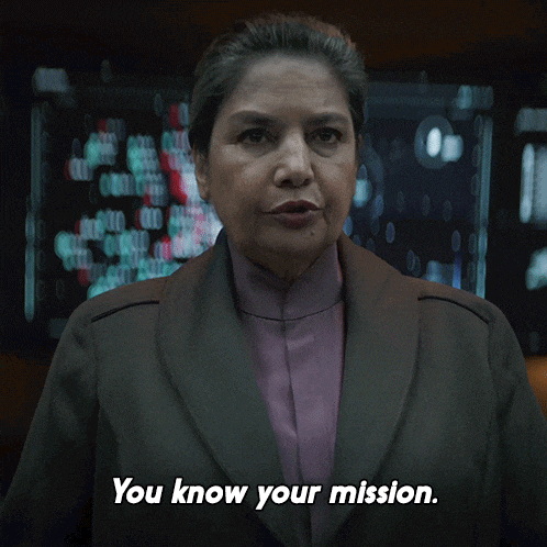 a woman says you know your mission in front of a monitor