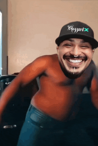 a shirtless man wearing a hat that says wizzard