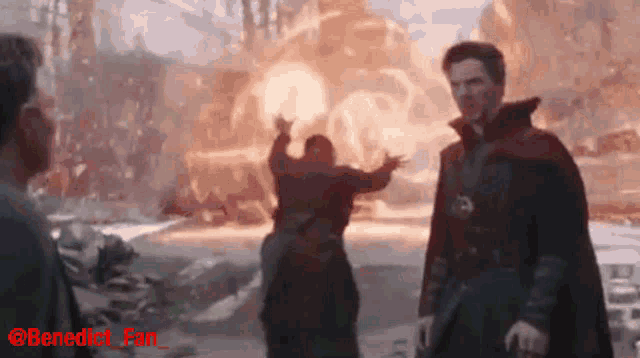 a man in a red cape is standing in front of an explosion and the words benedict fan are on the bottom