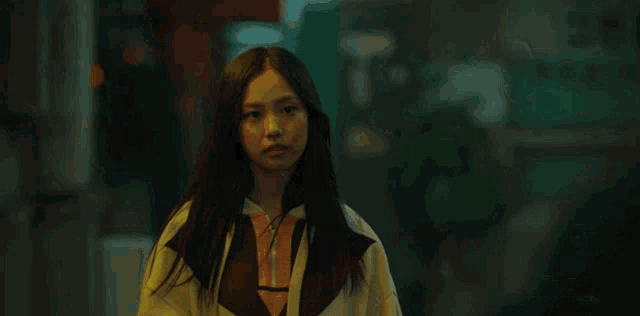 a girl with long hair is wearing a white sweatshirt with a triangle on it