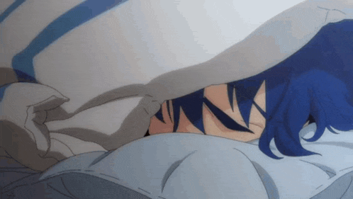 a person with blue hair laying under a blanket