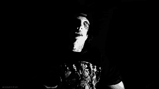 a black and white photo of a man 's face with a drawing on it .