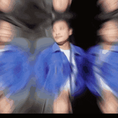 a blurry image of a man in a blue shirt