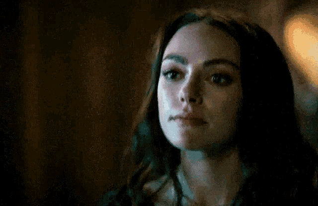 a close up of a woman 's face with tears coming out of her eyes .