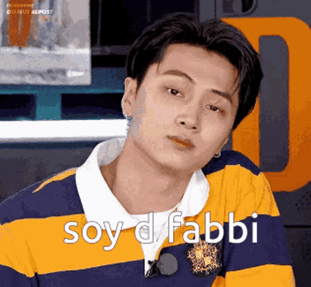 a young man is wearing a yellow and blue striped shirt and says soy d fabbi