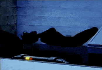 a silhouette of a person laying down in a room