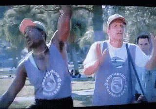 two men are dancing in a park and one of them is wearing a shirt that says smooth hound