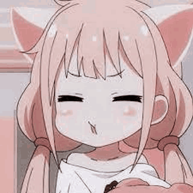 a close up of a girl with cat ears making a face .