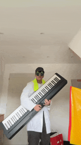 a man in a white coat is holding a very long keyboard