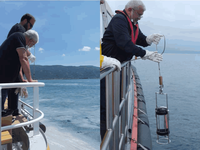 two men are standing on a boat looking at something in the ocean