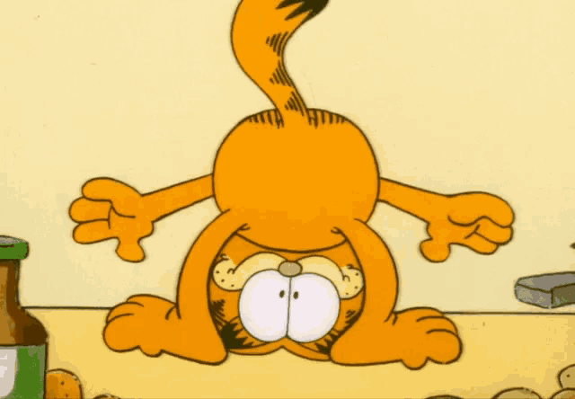 a cartoon of garfield doing a handstand in front of some potatoes