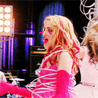 a woman in a pink dress and gloves is tied up