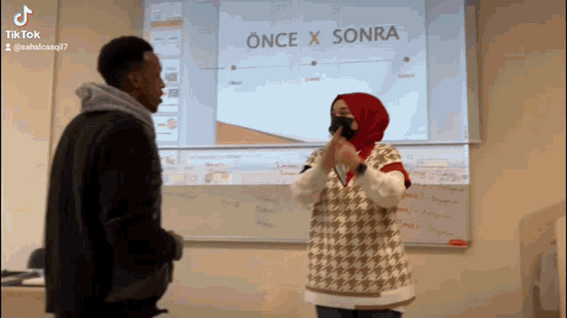 a man and a woman are standing in front of a projector screen that says önce x sonra