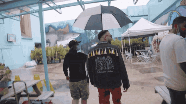 a man wearing a jacket that says ' king ' on the back